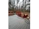 Grey deck with red railings surrounding an inground pool at 6625 Starling Sw Pl, Mableton, GA 30126