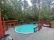 Backyard pool surrounded by gray decking, a wooden fence, and a covered outdoor area at 6625 Starling Sw Pl, Mableton, GA 30126