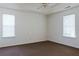 This is a bedroom with neutral walls, carpet, and a ceiling fan at 6715 Biscayne Blvd, Rex, GA 30273