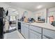 Kitchen features white cabinets and a view of the living room at 6715 Biscayne Blvd, Rex, GA 30273