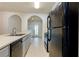 Galley style Kitchen with laminate countertops and open archways to other living areas at 6715 Biscayne Blvd, Rex, GA 30273