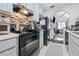 Kitchen includes black appliances and a stovetop at 6715 Biscayne Blvd, Rex, GA 30273