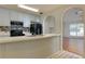 Functional kitchen featuring laminate countertops, a breakfast bar, and open access to the living room at 6715 Biscayne Blvd, Rex, GA 30273