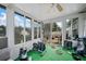 Sunroom with window views, exercise equipment and green carpet at 6715 Biscayne Blvd, Rex, GA 30273