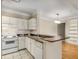 White kitchen with granite counters, appliances, and ample storage at 955 Juniper Ne St # 4331, Atlanta, GA 30309