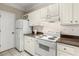 Kitchen boasts white cabinets, granite counters, and gas range at 955 Juniper Ne St # 4331, Atlanta, GA 30309