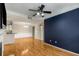 Open living room with hardwood floors, fireplace, and accent wall at 955 Juniper Ne St # 4331, Atlanta, GA 30309