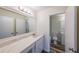 Updated bathroom with white vanity, quartz countertop, and marble shower at 1107 Riverbend Club Se Dr, Atlanta, GA 30339