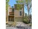 Tan two-story townhome with attached garage and landscaping at 1107 Riverbend Club Se Dr, Atlanta, GA 30339