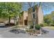 Two-story townhome with driveway, landscaping, and mature trees at 1107 Riverbend Club Se Dr, Atlanta, GA 30339
