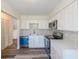Modern kitchen featuring white cabinets, stainless steel appliances, and luxury vinyl plank flooring at 1107 Riverbend Club Se Dr, Atlanta, GA 30339