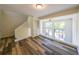 Living room with built-ins, hardwood floors, and deck access at 1107 Riverbend Club Se Dr, Atlanta, GA 30339