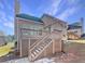 Home features a deck with stairs leading to the backyard at 3905 Colonial Sw Trl, Lilburn, GA 30047