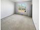 Bright bedroom with large window and neutral carpeting at 3905 Colonial Sw Trl, Lilburn, GA 30047