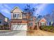 Brick two-story house with a large attached garage and manicured lawn at 3905 Colonial Sw Trl, Lilburn, GA 30047