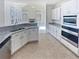 Eat-in kitchen with granite countertops and stainless steel appliances at 3905 Colonial Sw Trl, Lilburn, GA 30047