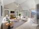 Bright living room with vaulted ceilings, built-in bookshelves, fireplace, and elegant staircase at 3905 Colonial Sw Trl, Lilburn, GA 30047