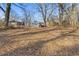 Large backyard with scattered leaves and mature trees at 1974 Browns Mill Se Rd, Atlanta, GA 30315
