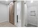 Modern bathroom with barn door and walk-in shower at 1974 Browns Mill Se Rd, Atlanta, GA 30315