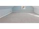 Spacious attic bedroom with light grey carpet and blue walls at 1974 Browns Mill Se Rd, Atlanta, GA 30315