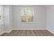 Simple bedroom with hardwood floors and large windows at 1974 Browns Mill Se Rd, Atlanta, GA 30315
