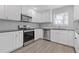 Modern kitchen with stainless steel appliances and white shaker cabinets at 1974 Browns Mill Se Rd, Atlanta, GA 30315