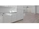 Open concept kitchen with white cabinets and view to living room at 1974 Browns Mill Se Rd, Atlanta, GA 30315