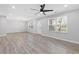 Bright living room featuring a modern fan, recessed lights and wood laminate flooring at 1974 Browns Mill Se Rd, Atlanta, GA 30315