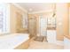 Elegant bathroom with soaking tub, glass shower, and tiled floors at 63 Habersham Cove Nw Ln, Atlanta, GA 30305