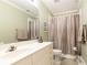 Clean bathroom with double vanity, shower, and toilet at 63 Habersham Cove Nw Ln, Atlanta, GA 30305