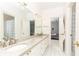 Double vanity bathroom with granite countertop and view into bedroom at 63 Habersham Cove Nw Ln, Atlanta, GA 30305