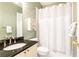 Clean bathroom with shower/tub combo and dark vanity at 63 Habersham Cove Nw Ln, Atlanta, GA 30305