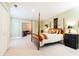 Spacious bedroom with post bed, carpet, and access to other rooms at 63 Habersham Cove Nw Ln, Atlanta, GA 30305