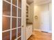 Butlers pantry with granite countertop, glass-front cabinets, and hardwood floors at 63 Habersham Cove Nw Ln, Atlanta, GA 30305