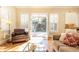 Sunlit Gathering room features french doors opening to backyard, hardwood floors, and comfortable seating at 63 Habersham Cove Nw Ln, Atlanta, GA 30305