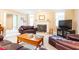 Cozy living room with fireplace, brown leather furniture, and large TV at 63 Habersham Cove Nw Ln, Atlanta, GA 30305