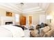 Main bedroom with sitting area, fireplace, and access to bathroom at 63 Habersham Cove Nw Ln, Atlanta, GA 30305