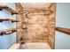 Updated bathroom with tile shower/tub combo and wooden shelves at 758 Shoreline Se Trl, Conyers, GA 30094