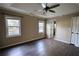 Main bedroom with wood-look floors, ceiling fan, and access to bathroom at 758 Shoreline Se Trl, Conyers, GA 30094