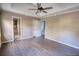 Main bedroom with wood-look floors, ceiling fan, and access to bathroom at 758 Shoreline Se Trl, Conyers, GA 30094