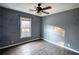 Bright bedroom featuring wood-look floors and a ceiling fan at 758 Shoreline Se Trl, Conyers, GA 30094