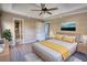 Main bedroom with wood-look floors, ceiling fan, and access to bathroom at 758 Shoreline Se Trl, Conyers, GA 30094