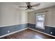 Bedroom with hardwood floors, ceiling fan, and two-tone walls at 758 Shoreline Se Trl, Conyers, GA 30094
