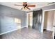 Bedroom with barn door, wood-look floors, and ceiling fan at 758 Shoreline Se Trl, Conyers, GA 30094