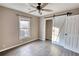 Bedroom with hardwood floors, ceiling fan, and barn door at 758 Shoreline Se Trl, Conyers, GA 30094