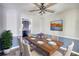 Dining room with hardwood floors, staged table, and kitchen view at 758 Shoreline Se Trl, Conyers, GA 30094
