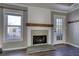 Fireplace with stone surround and mantel, hardwood floors, and French doors at 758 Shoreline Se Trl, Conyers, GA 30094