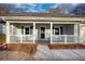 Inviting front porch with white railings and landscaping at 758 Shoreline Se Trl, Conyers, GA 30094