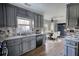 Renovated kitchen with gray cabinets, granite countertops, and stainless steel appliances at 758 Shoreline Se Trl, Conyers, GA 30094