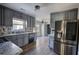 Renovated kitchen with gray cabinets, granite countertops, and stainless steel appliances at 758 Shoreline Se Trl, Conyers, GA 30094